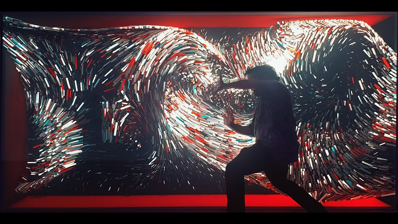 Visitors moving in front of FLOW, an interactive projection artwork that responds to their bodies, BEYOND TLV