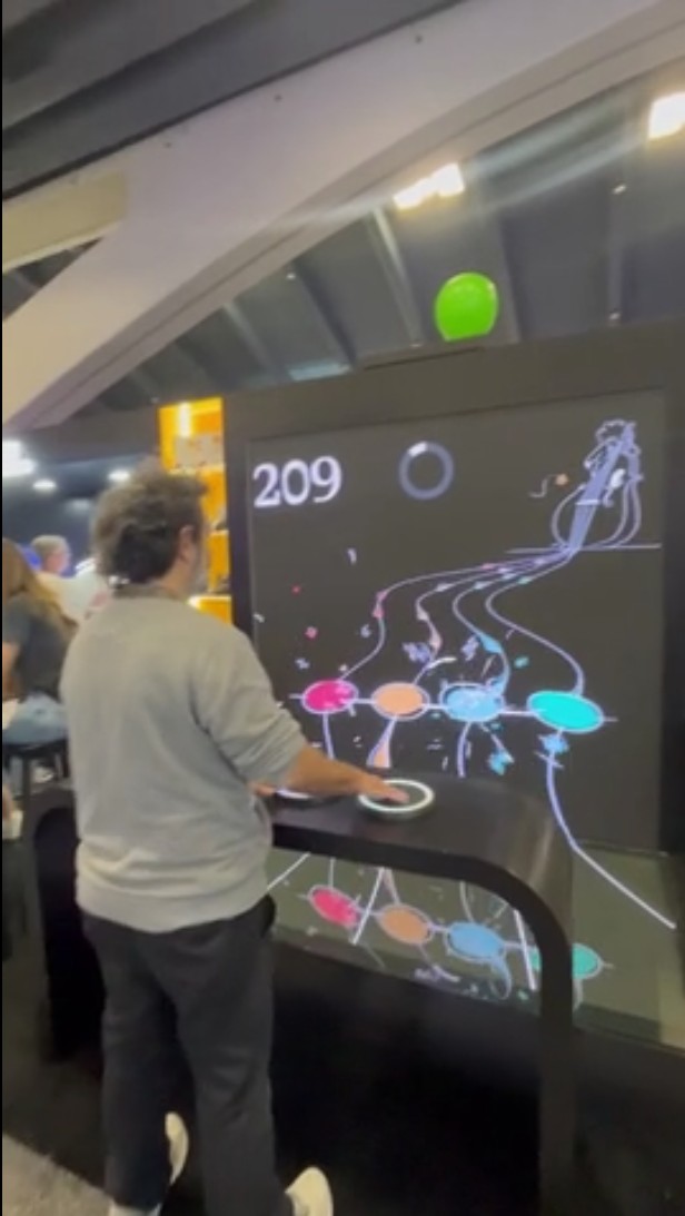 Visitor playing a four-pad interactive rhythm game at the Jazz booth, RSA Conference